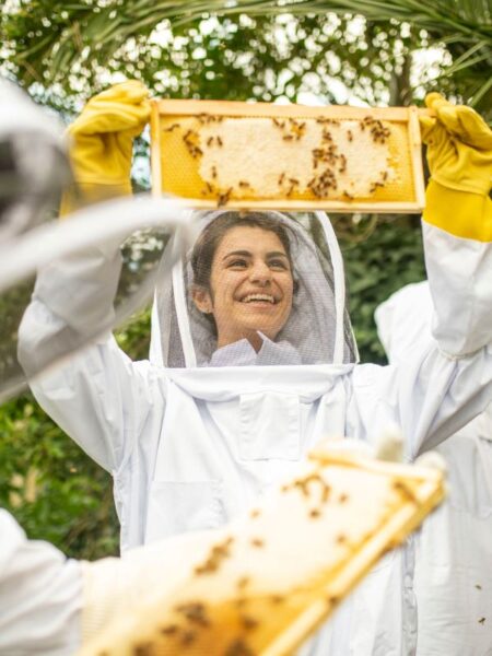 Woman dressed in beekeeping outfit