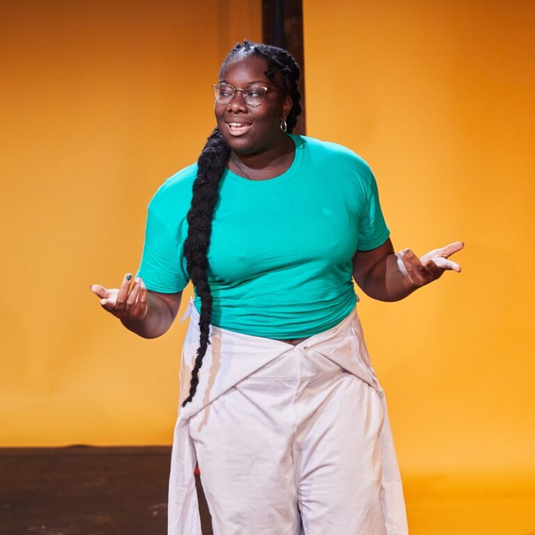 A female performer from the Bush Theatre company.