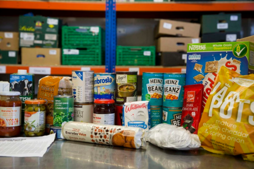 A collection of food, including baked beans, cereal and biscuits.