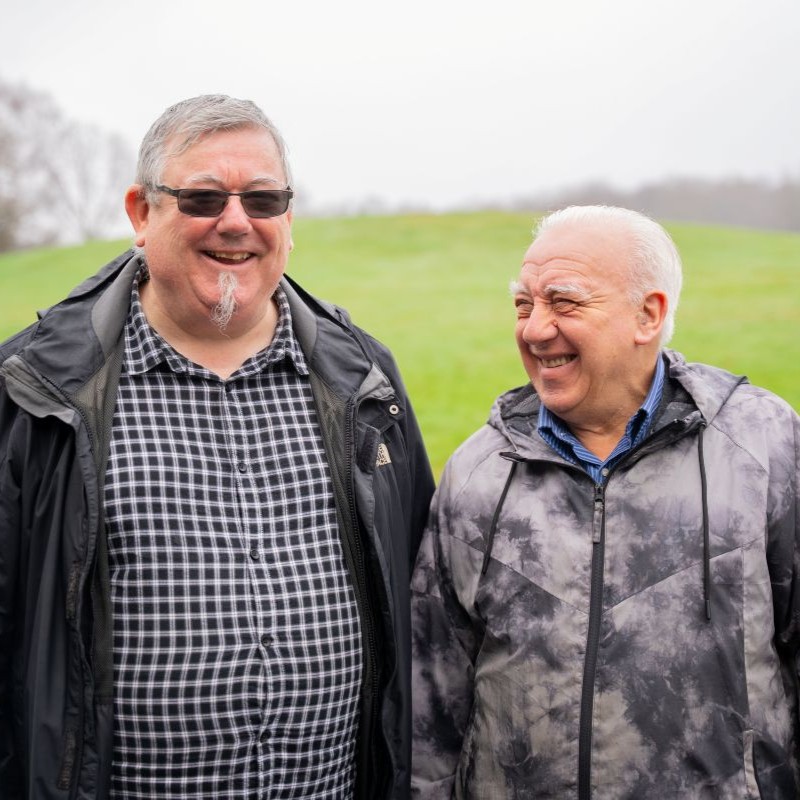Two men over 60 talking and laughing.