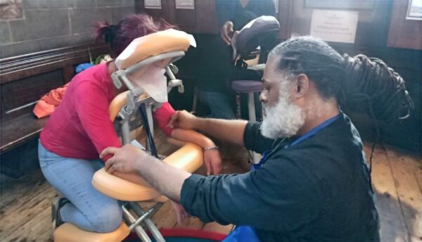 A man giving a client a hand and arm massage