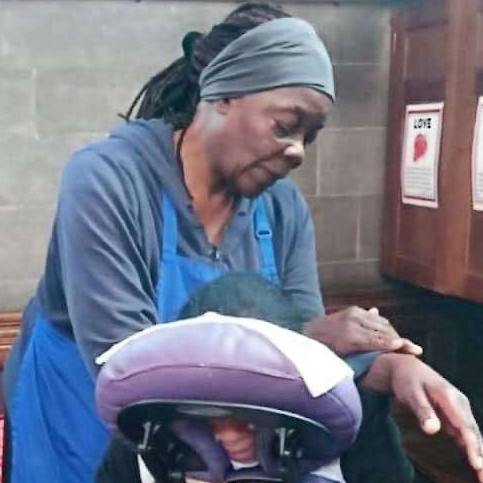 A woman giving someone a hand massage