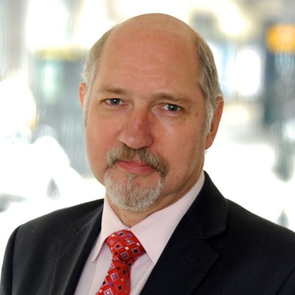 Hammersmith United Charities' new Chair, Guy Vincent. He is a white man with a beard and moustache.