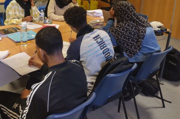 A group of  teenage students at a table