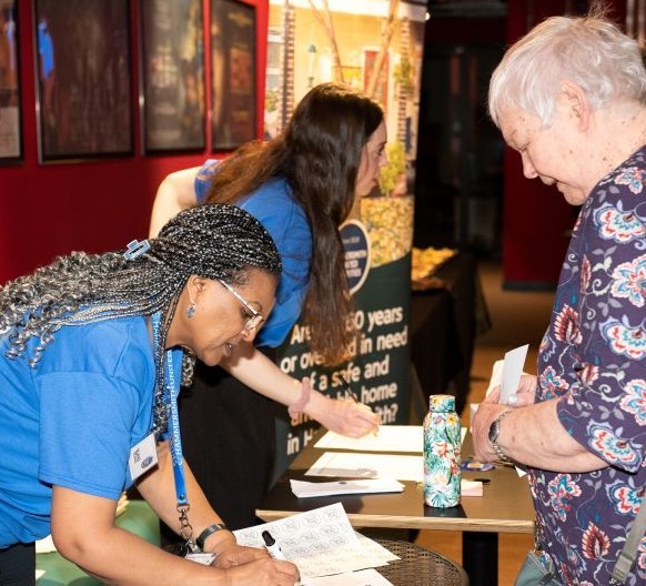 Hetty and Paige checking names against the register