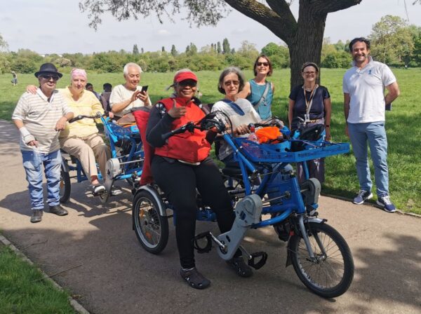 A group of people on or around a shared bicycle