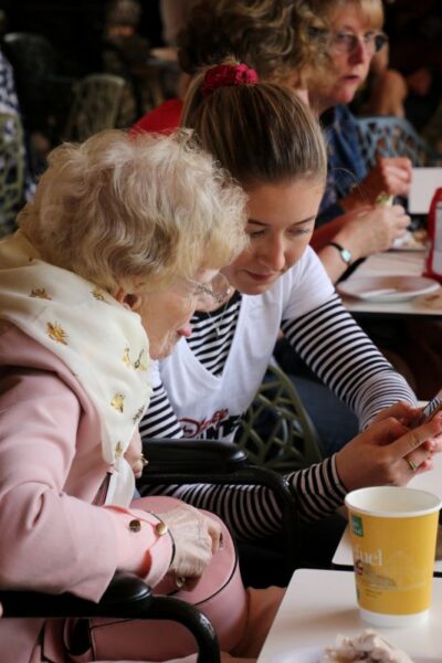 Two women: One is a younger volunteer, the other is the older woman she is supporting