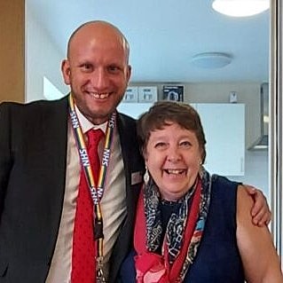 Lorraine and out scheme manager Chris, smiling at the camera. Chris' arm is around Lorraine's shoulders.
